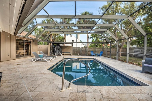 view of pool featuring a fenced backyard, a patio area, and glass enclosure