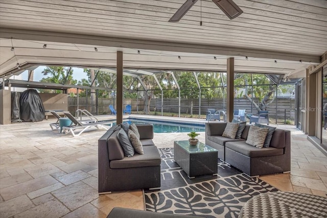 view of swimming pool with outdoor lounge area, a fenced backyard, a patio, and a ceiling fan