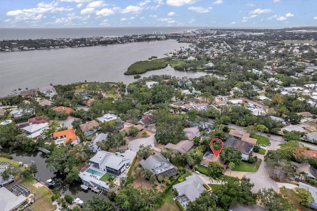 aerial view of property's location featuring a nearby body of water and nearby suburban area