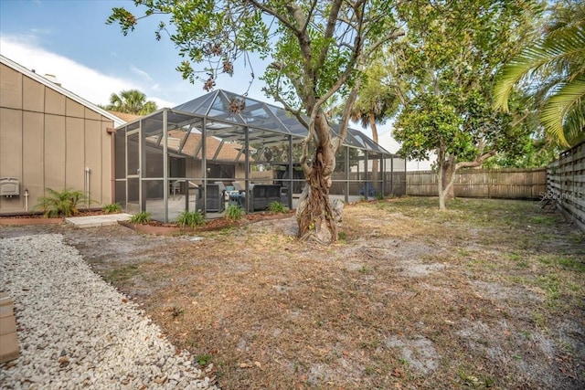 fenced backyard with a patio area and a lanai