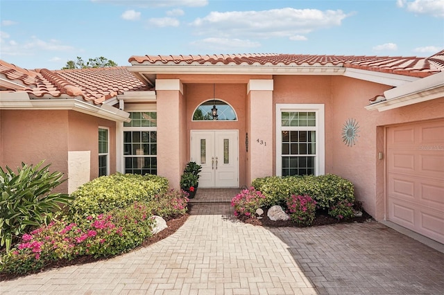431 Fieldstone Dr, Venice, FL 34292 - entrance to property featuring an attached garage, stucco siding, a tile roof, and decorative driveway