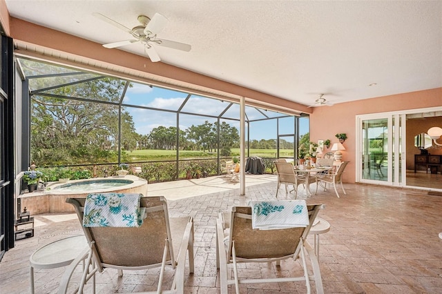 431 Fieldstone Dr, Venice, FL 34292 - sunroom featuring a hot tub, ceiling fan, and outdoor dining space