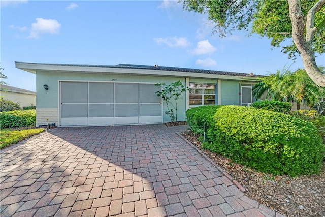 2607 Lancaster Dr Unit 35, Sun City Center, FL 33573 - single story home featuring decorative driveway, a garage, and stucco siding