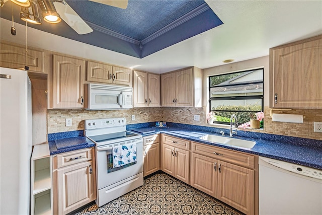 2607 Lancaster Dr Unit 35, Sun City Center, FL 33573 - kitchen with white appliances, a sink, light brown cabinets, dark countertops, and a tray ceiling