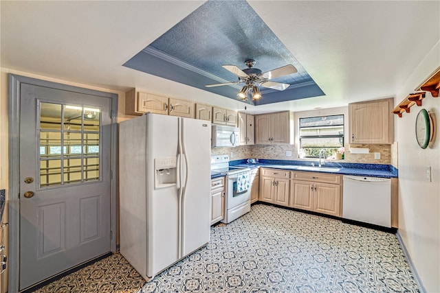 2607 Lancaster Dr Unit 35, Sun City Center, FL 33573 - kitchen with white appliances, a raised ceiling, a sink, and light brown cabinets