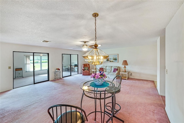 2607 Lancaster Dr Unit 35, Sun City Center, FL 33573 - carpeted living room featuring a textured ceiling, a chandelier, ceiling fan, and baseboards