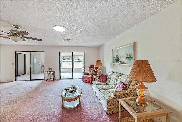 2607 Lancaster Dr Unit 35, Sun City Center, FL 33573 - living area featuring carpet flooring, a textured ceiling, and ceiling fan