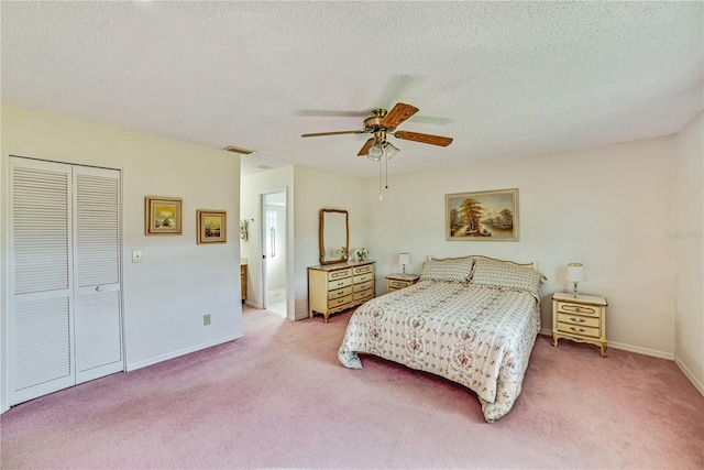 2607 Lancaster Dr Unit 35, Sun City Center, FL 33573 - carpeted bedroom featuring a textured ceiling, baseboards, a closet, and ceiling fan