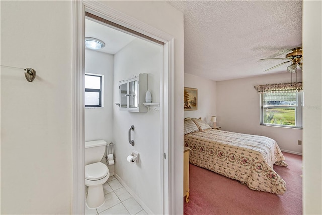 2607 Lancaster Dr Unit 35, Sun City Center, FL 33573 - tiled bedroom featuring a textured ceiling, ceiling fan, and baseboards