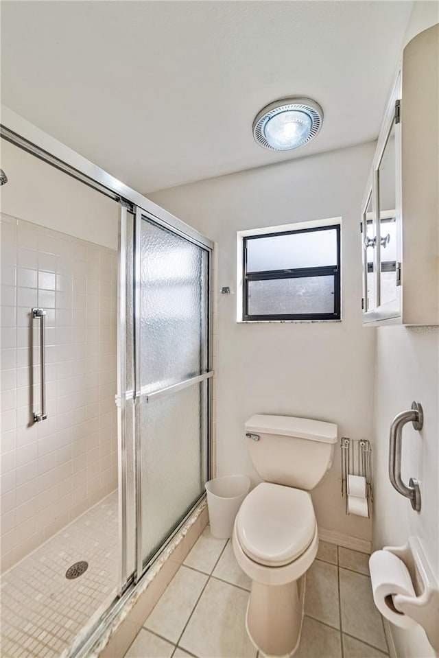 2607 Lancaster Dr Unit 35, Sun City Center, FL 33573 - bathroom featuring toilet, tile patterned flooring, and a stall shower