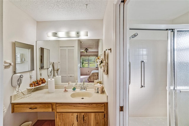 2607 Lancaster Dr Unit 35, Sun City Center, FL 33573 - bathroom with a shower stall, ensuite bathroom, a ceiling fan, vanity, and a textured ceiling