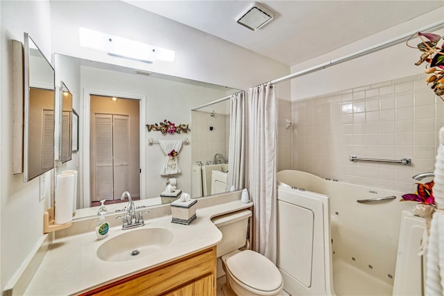 2607 Lancaster Dr Unit 35, Sun City Center, FL 33573 - full bathroom featuring toilet, a combined bath / shower with jetted tub, and vanity