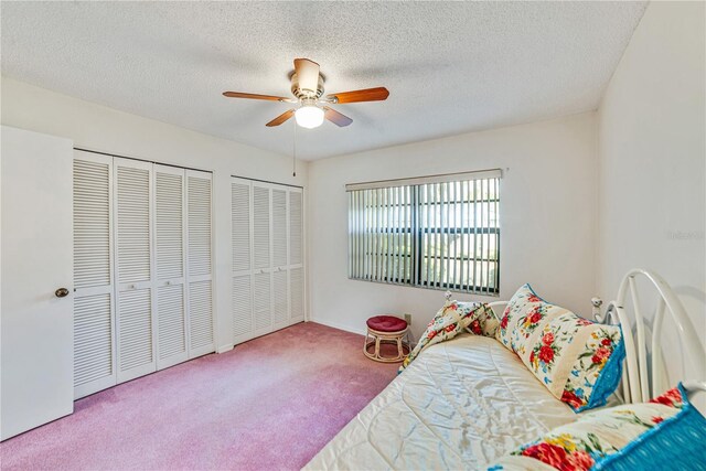 2607 Lancaster Dr Unit 35, Sun City Center, FL 33573 - carpeted bedroom with a textured ceiling, ceiling fan, multiple closets, and baseboards