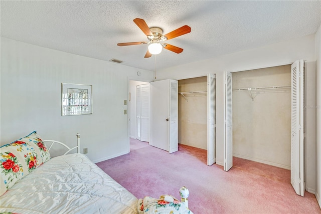 2607 Lancaster Dr Unit 35, Sun City Center, FL 33573 - carpeted bedroom featuring multiple closets, a ceiling fan, and baseboards