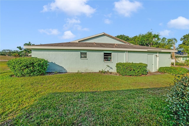2607 Lancaster Dr Unit 35, Sun City Center, FL 33573 - view of side of property with a lawn and stucco siding