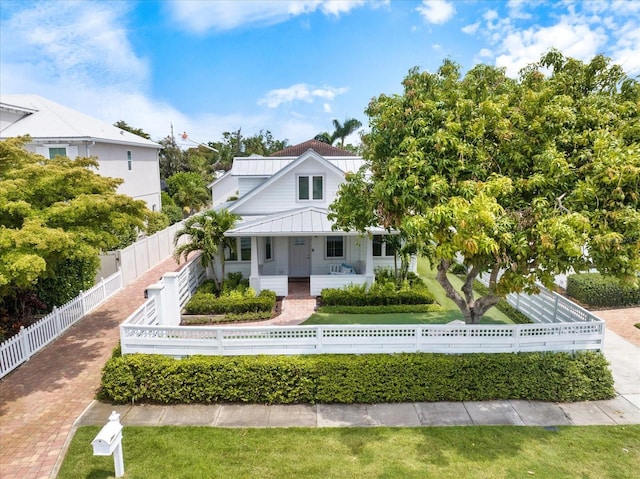 1841 Datura St, Sarasota, FL 34239 - view of front of house with a porch, a standing seam roof, metal roof, and a fenced front yard