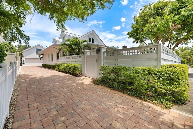 1841 Datura St, Sarasota, FL 34239 - view of front of home featuring a fenced front yard, a standing seam roof, and a gate