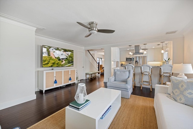 1841 Datura St, Sarasota, FL 34239 - living room featuring ceiling fan, crown molding, wood finished floors, and baseboards