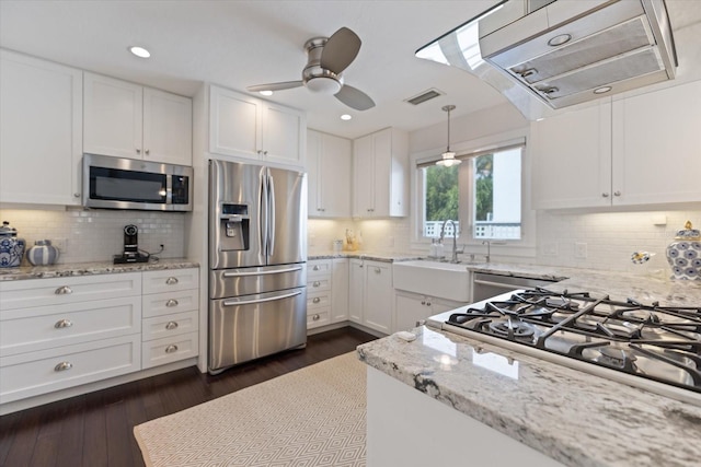 1841 Datura St, Sarasota, FL 34239 - kitchen with appliances with stainless steel finishes, under cabinet range hood, white cabinets, ceiling fan, and dark wood-type flooring