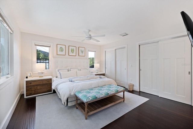 1841 Datura St, Sarasota, FL 34239 - bedroom featuring two closets, dark wood-style flooring, multiple windows, and ceiling fan