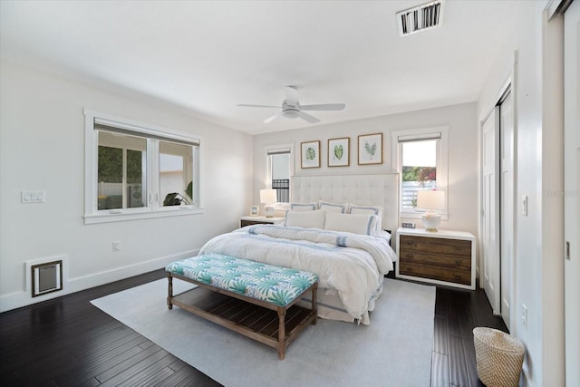 1841 Datura St, Sarasota, FL 34239 - bedroom with dark wood-type flooring, a closet, baseboards, and a ceiling fan