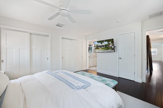 1841 Datura St, Sarasota, FL 34239 - bedroom featuring dark wood-style flooring, baseboards, multiple closets, ensuite bathroom, and ceiling fan