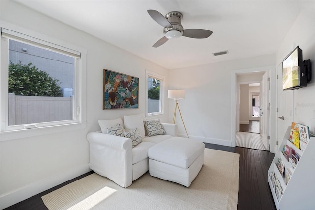 1841 Datura St, Sarasota, FL 34239 - living area featuring a ceiling fan, wood finished floors, and baseboards
