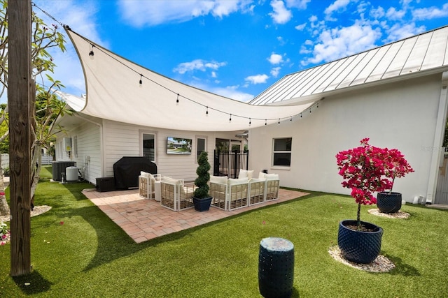 1841 Datura St, Sarasota, FL 34239 - rear view of property featuring a standing seam roof, a patio, central AC unit, an outdoor hangout area, and a yard