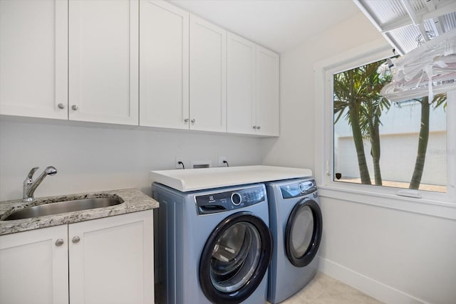 1841 Datura St, Sarasota, FL 34239 - washroom with cabinet space, washer and dryer, light tile patterned floors, and baseboards