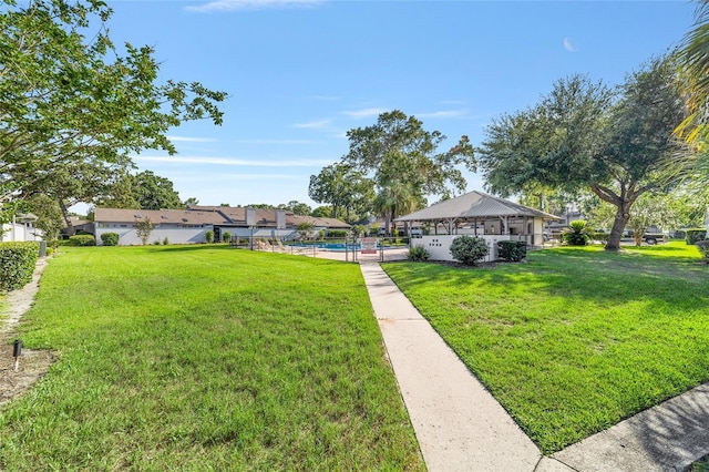 view of yard featuring a pool and a gazebo