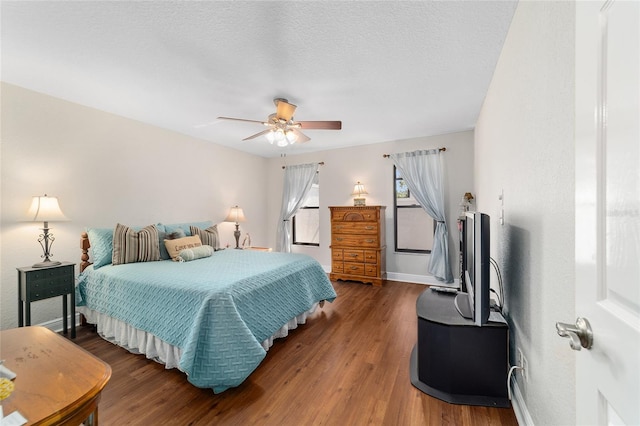 bedroom with wood finished floors, ceiling fan, and baseboards