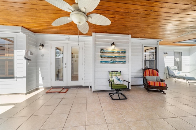 view of exterior entry with french doors, a patio, and ceiling fan