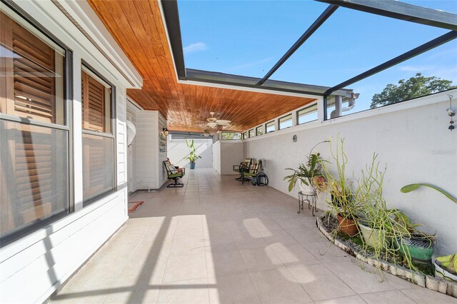 view of patio / terrace featuring ceiling fan and a lanai