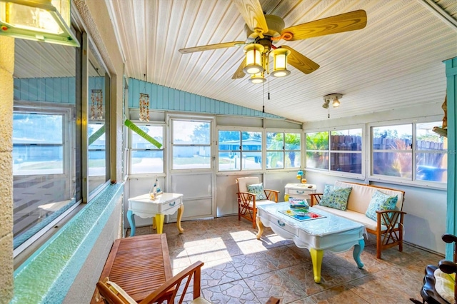 sunroom / solarium with vaulted ceiling, a ceiling fan, and an outdoor hangout area