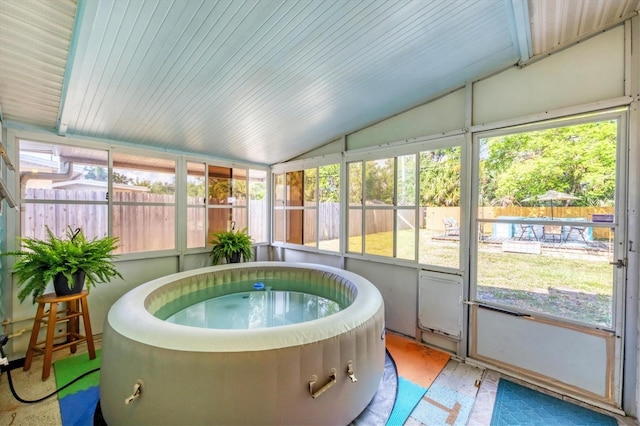 sunroom with vaulted ceiling and a jacuzzi