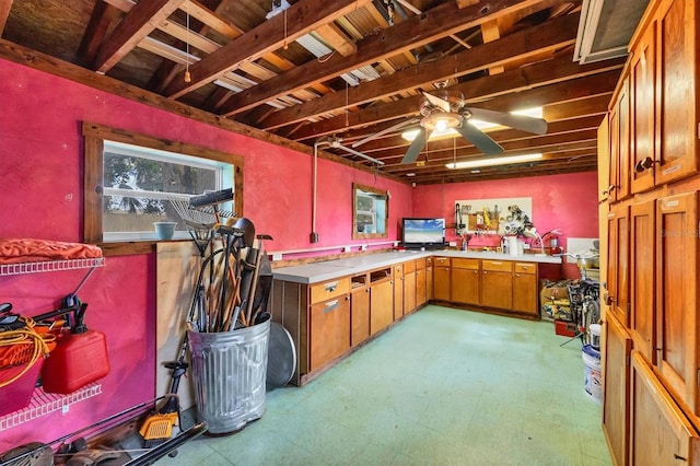 basement with a ceiling fan and tile patterned floors