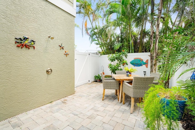 229 S Harbor Dr, Holmes Beach, FL 34217 - fenced backyard featuring a patio, outdoor dining area, and a gate