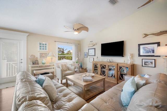 229 S Harbor Dr, Holmes Beach, FL 34217 - living area with ceiling fan, wood finished floors, vaulted ceiling, and a textured ceiling