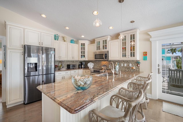 229 S Harbor Dr, Holmes Beach, FL 34217 - kitchen featuring appliances with stainless steel finishes, a sink, backsplash, stone countertops, and recessed lighting