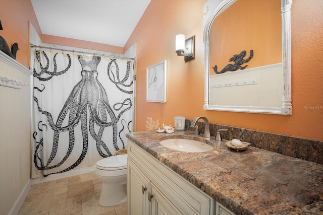 229 S Harbor Dr, Holmes Beach, FL 34217 - full bathroom with vanity, toilet, a shower with curtain, vaulted ceiling, and baseboards