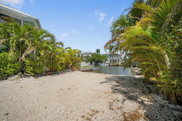 229 S Harbor Dr, Holmes Beach, FL 34217 - view of yard with a boat ramp, a water view, and a boat dock