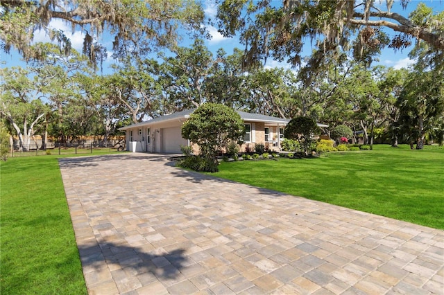 view of front of home with an attached garage and decorative driveway