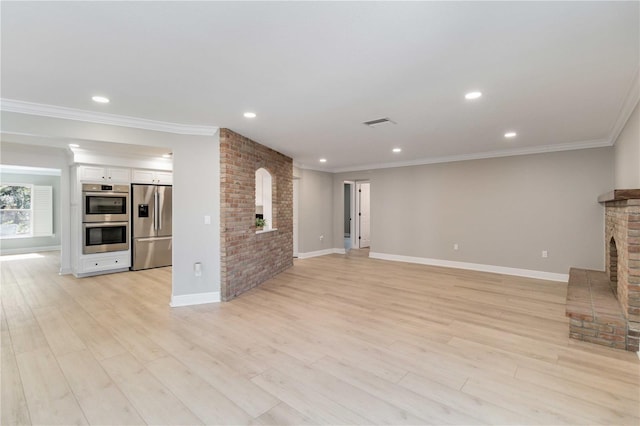 unfurnished living room featuring a fireplace, crown molding, light wood finished floors, baseboards, and recessed lighting