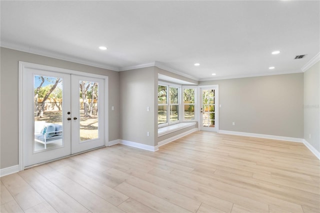 unfurnished living room featuring crown molding, plenty of natural light, french doors, light wood finished floors, and recessed lighting
