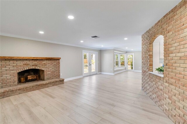 unfurnished living room with light wood-style floors, french doors, baseboards, recessed lighting, and a fireplace