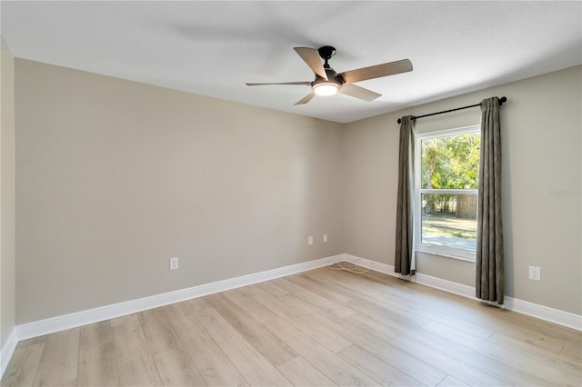 unfurnished room with light wood-style floors, ceiling fan, and baseboards