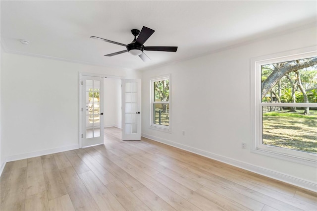 unfurnished room with french doors, light wood-style floors, baseboards, and ceiling fan