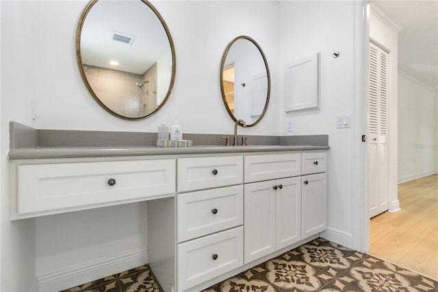 bathroom featuring vanity and baseboards