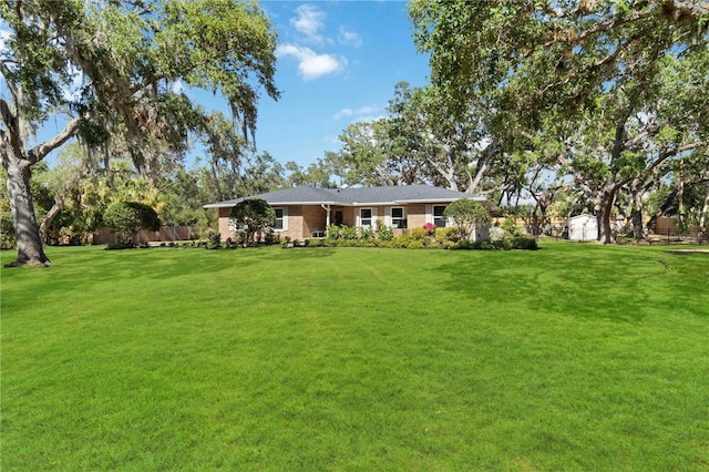 view of front facade featuring a front lawn and brick siding