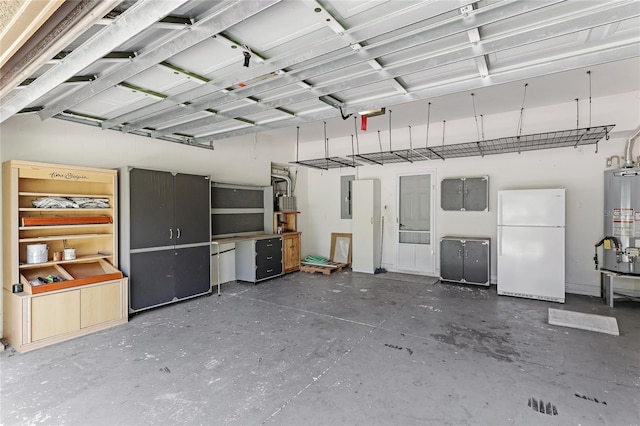 garage with freestanding refrigerator, water heater, and electric panel
